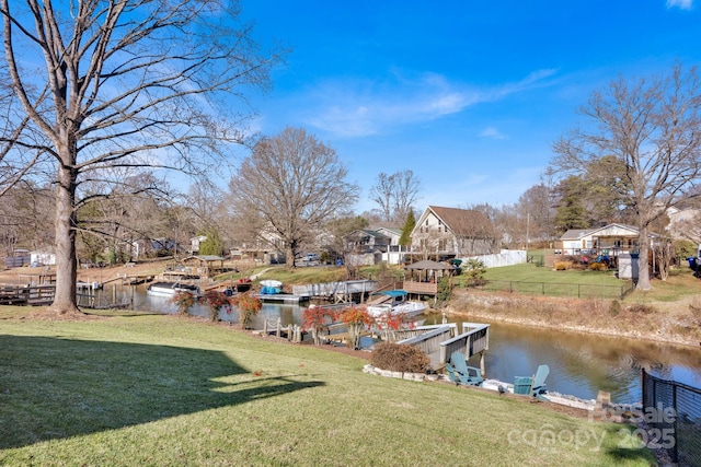 view of yard with a dock and a water view