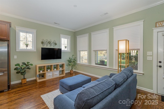 living room featuring a wealth of natural light, dark hardwood / wood-style flooring, and ornamental molding