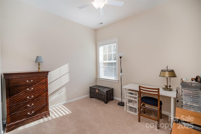 carpeted office space featuring ceiling fan