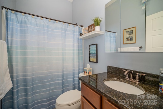 bathroom featuring vanity and toilet