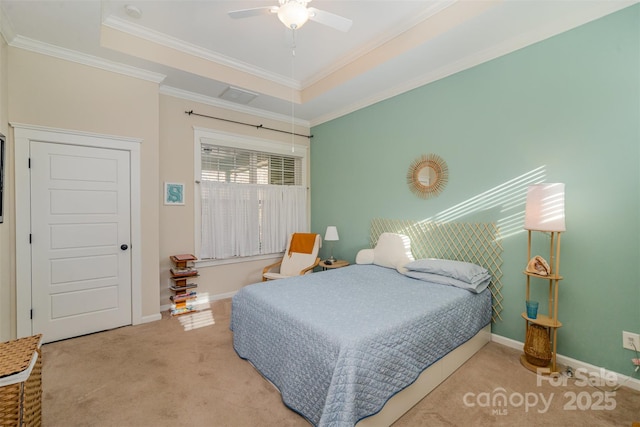 bedroom featuring a tray ceiling, ceiling fan, carpet, and ornamental molding