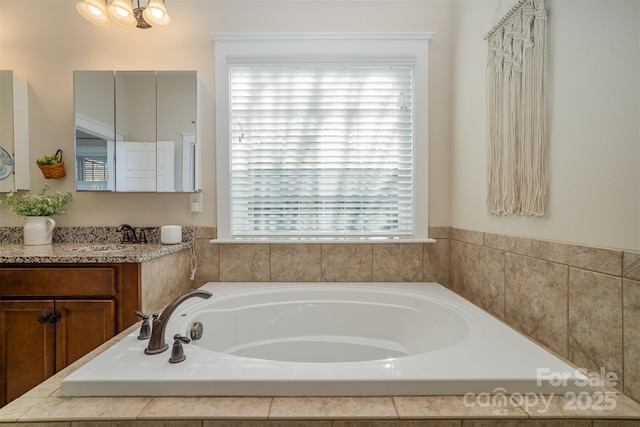 bathroom featuring a washtub and vanity