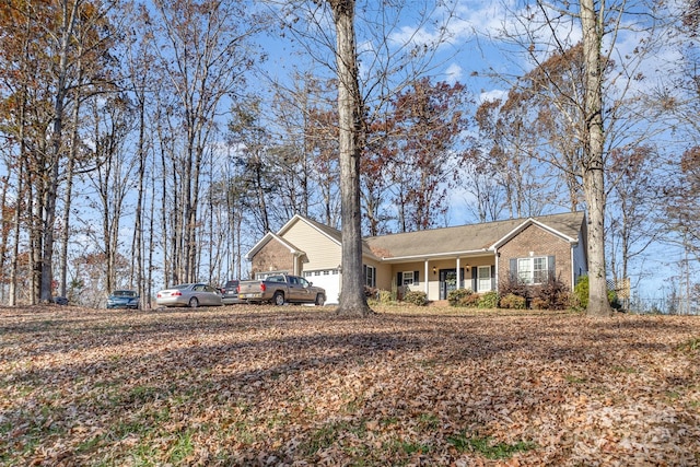 single story home with covered porch and a garage