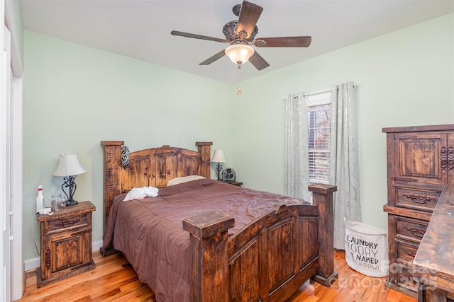 bedroom with ceiling fan and light hardwood / wood-style floors