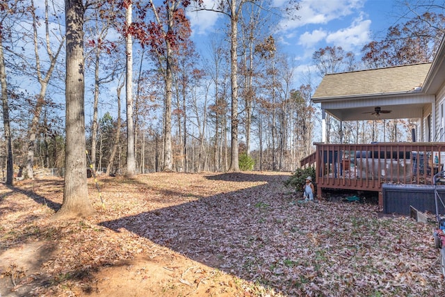 view of yard featuring ceiling fan and a wooden deck