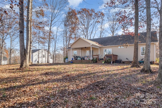 rear view of property featuring central air condition unit, ceiling fan, and covered porch