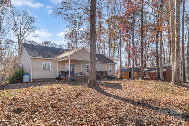 exterior space featuring ceiling fan, a porch, and a storage unit