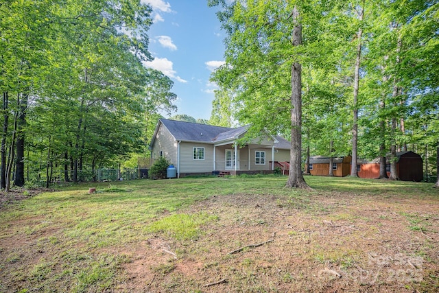 1313 Western Hills Ln, Vale, NC 28168 - view of front of home featuring an outdoor structure, a shed, a front yard, and fence