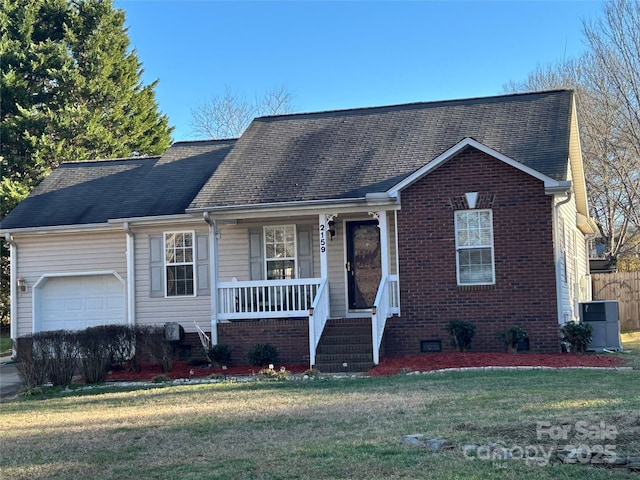 view of front of home featuring a garage, a front yard, and covered porch