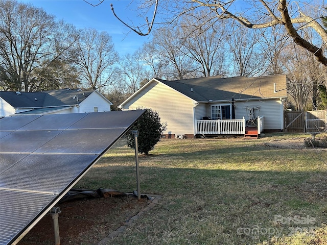 view of property exterior with a lawn and solar panels