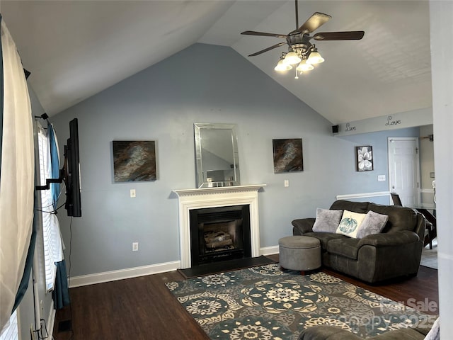 living room with ceiling fan, dark wood-type flooring, a wealth of natural light, and lofted ceiling