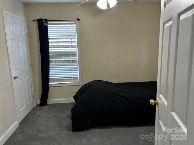 bedroom featuring ceiling fan and dark carpet