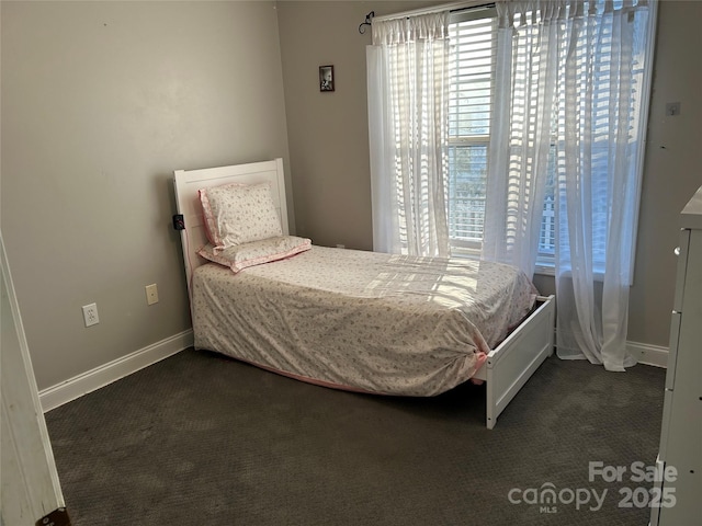 bedroom featuring dark carpet