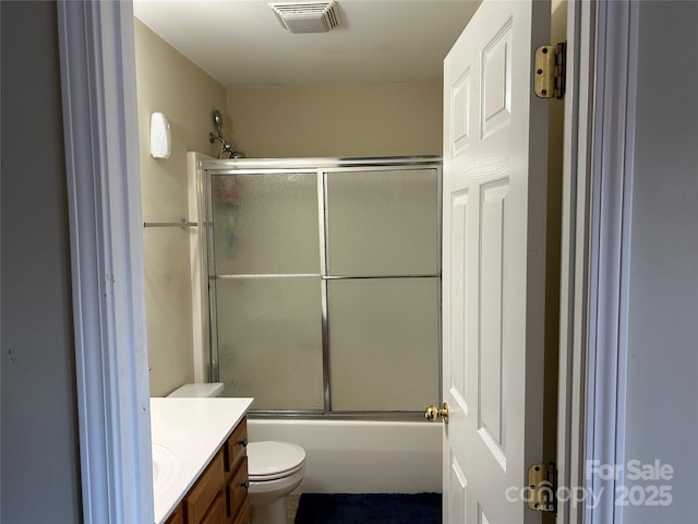 full bathroom with toilet, vanity, and shower / bath combination with glass door