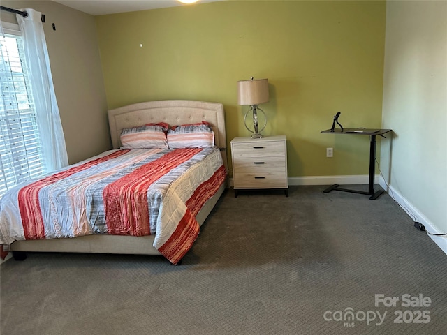 bedroom with dark colored carpet