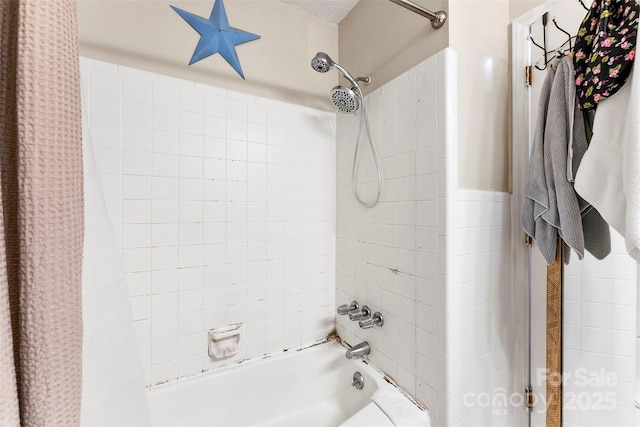 bathroom with shower / bathtub combination with curtain