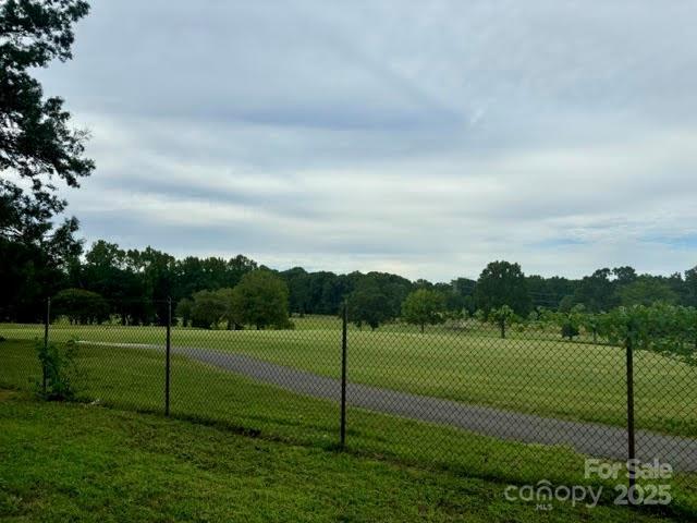 view of home's community with a lawn and a rural view