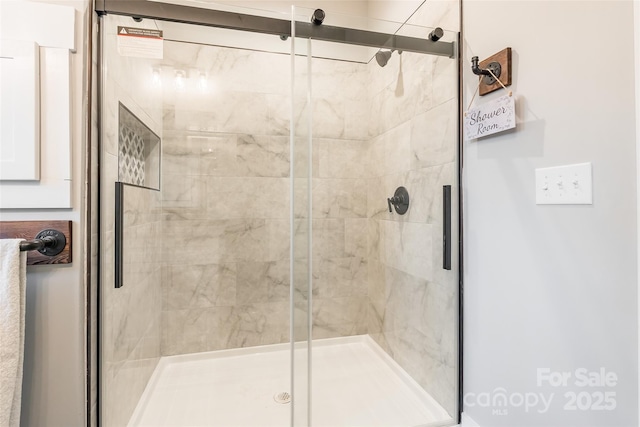 bathroom featuring a shower with door