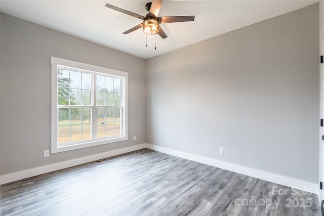 empty room featuring hardwood / wood-style floors and ceiling fan