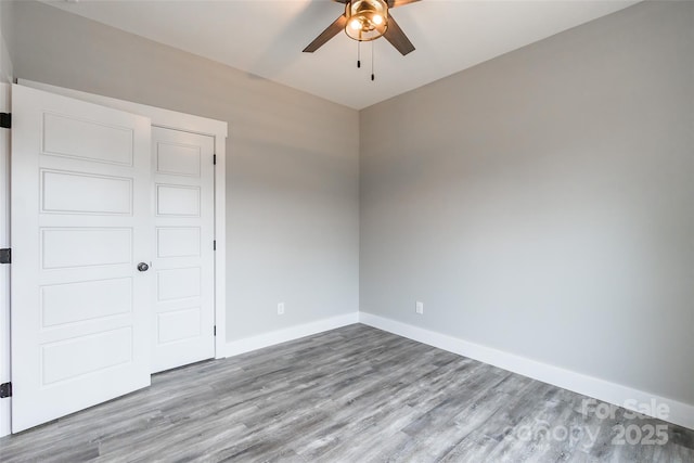 unfurnished bedroom with light wood-type flooring, a closet, and ceiling fan