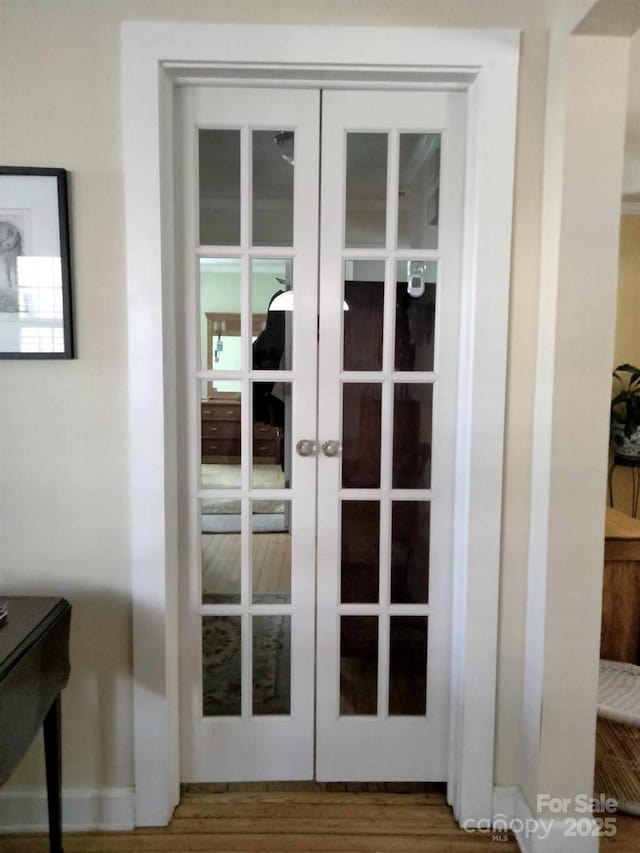 doorway to outside featuring french doors and wood finished floors