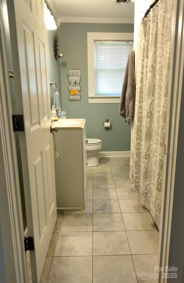 full bath with toilet, ornamental molding, vanity, tile patterned flooring, and baseboards