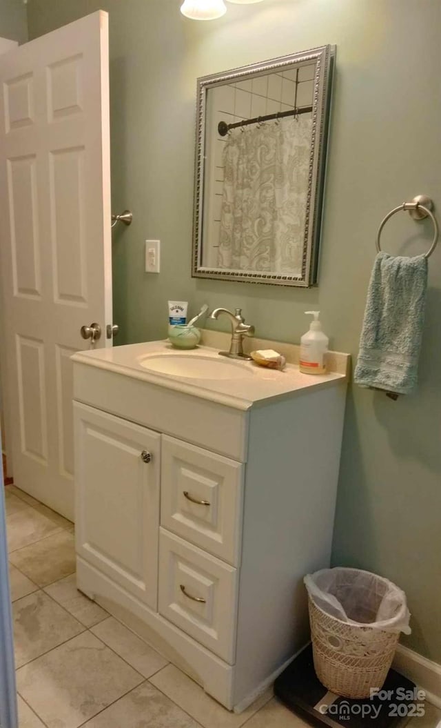 full bath with tile patterned floors, baseboards, curtained shower, and vanity