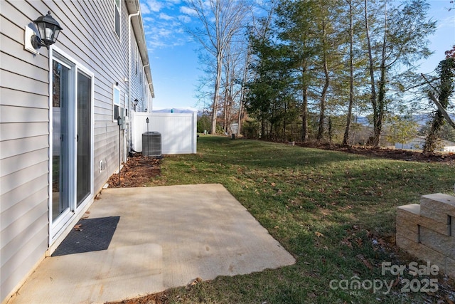 view of yard with central AC unit and a patio area