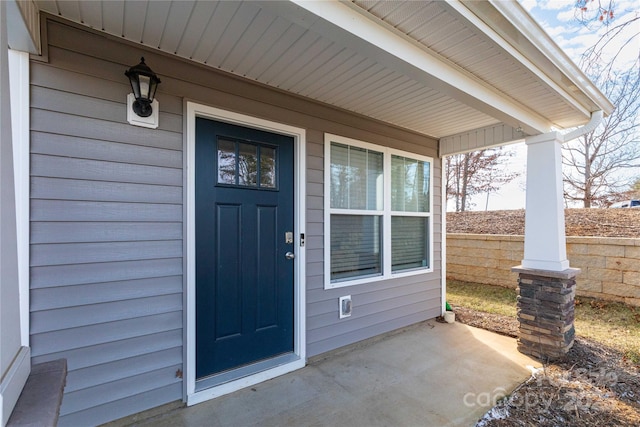 view of exterior entry with a porch