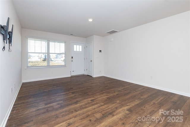 spare room featuring dark hardwood / wood-style floors