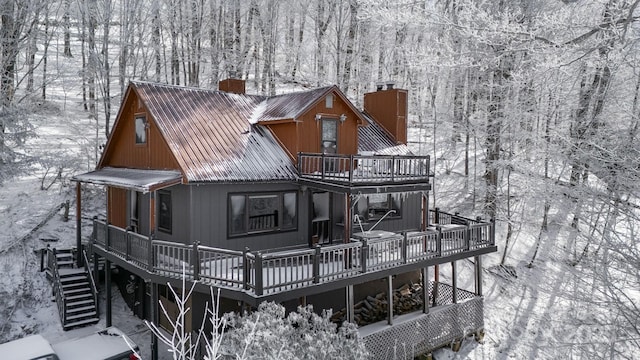 snow covered property featuring a wooden deck