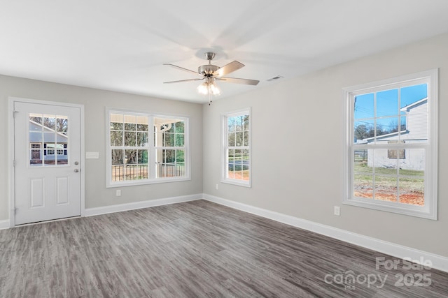 empty room with wood-type flooring and ceiling fan