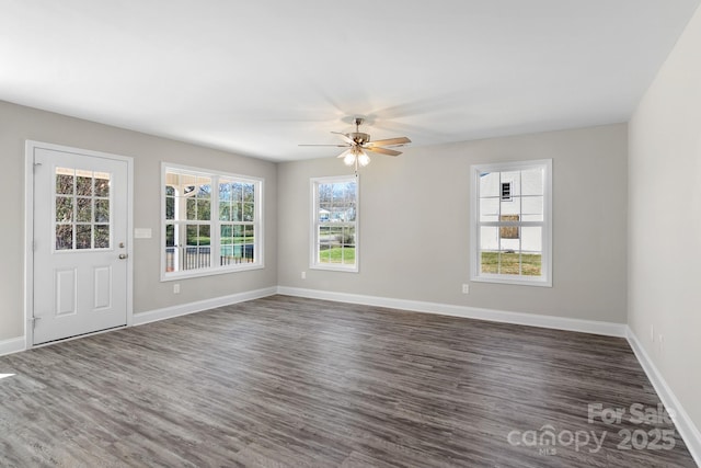 unfurnished room featuring ceiling fan, plenty of natural light, and dark hardwood / wood-style flooring