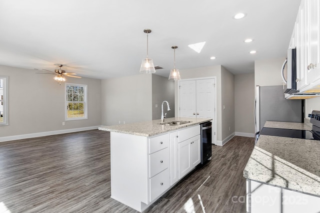 kitchen with pendant lighting, sink, dishwasher, white cabinetry, and a center island with sink