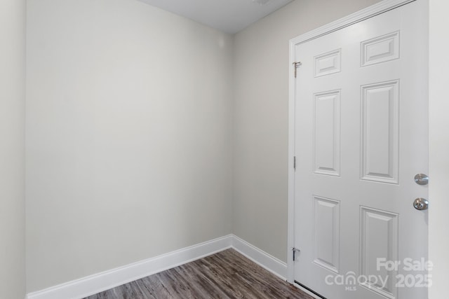 unfurnished room featuring dark wood-type flooring