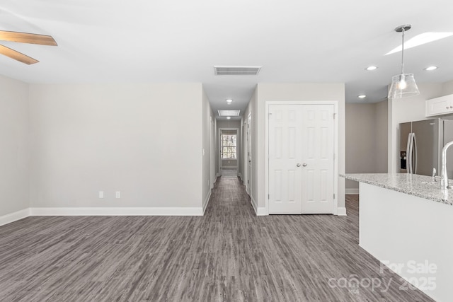 interior space with dark wood-type flooring, ceiling fan, and sink