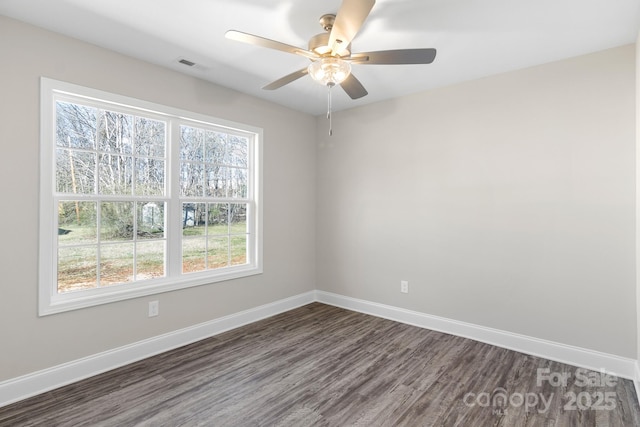 empty room with dark wood-type flooring and ceiling fan