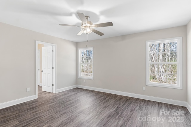 unfurnished room with ceiling fan, dark hardwood / wood-style floors, and a wealth of natural light