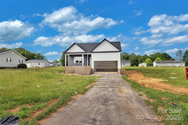 143 Tranquility Ln, Harmony, NC 28634 - view of front of house with driveway, a garage, board and batten siding, and brick siding