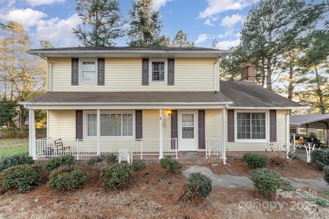 view of front of property with a carport and covered porch