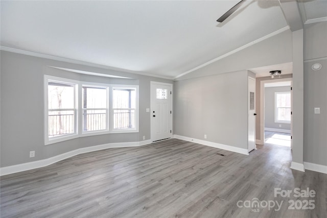 interior space with light hardwood / wood-style flooring, vaulted ceiling, ceiling fan, and ornamental molding