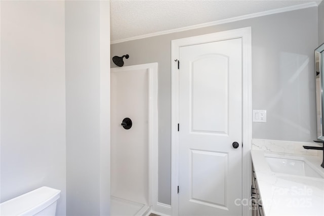 bathroom with vanity, toilet, a shower, and a textured ceiling