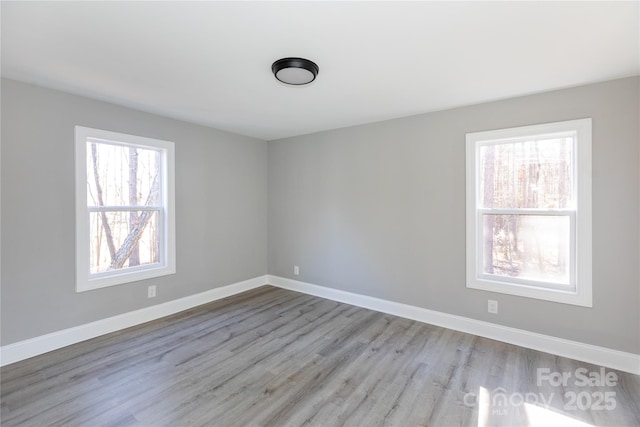 unfurnished room with light wood-type flooring