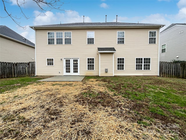 back of property with a patio area and a yard