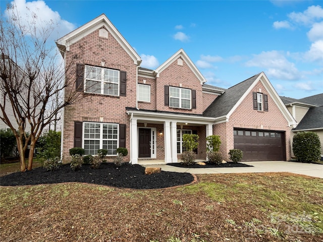 view of front of home with a garage and a front lawn