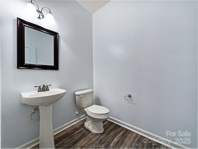 bathroom with sink, hardwood / wood-style floors, and toilet