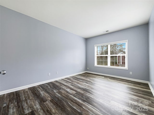 unfurnished room with wood-type flooring