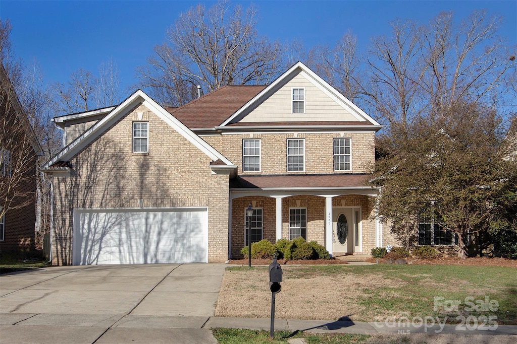 view of property with a garage and a porch