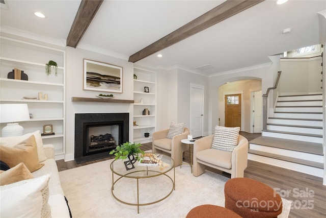 living room with crown molding, beamed ceiling, and dark hardwood / wood-style floors