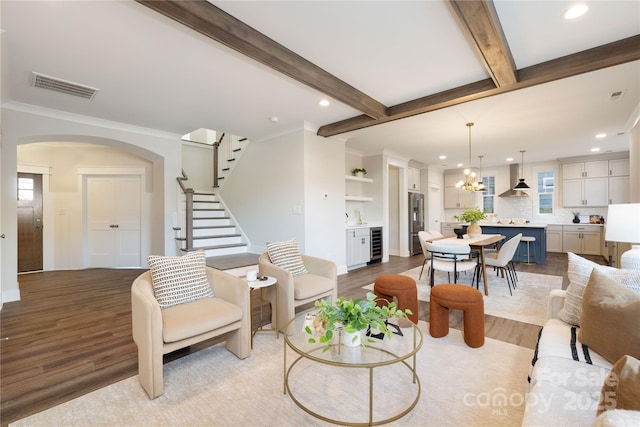 living room featuring light hardwood / wood-style flooring, beverage cooler, and plenty of natural light